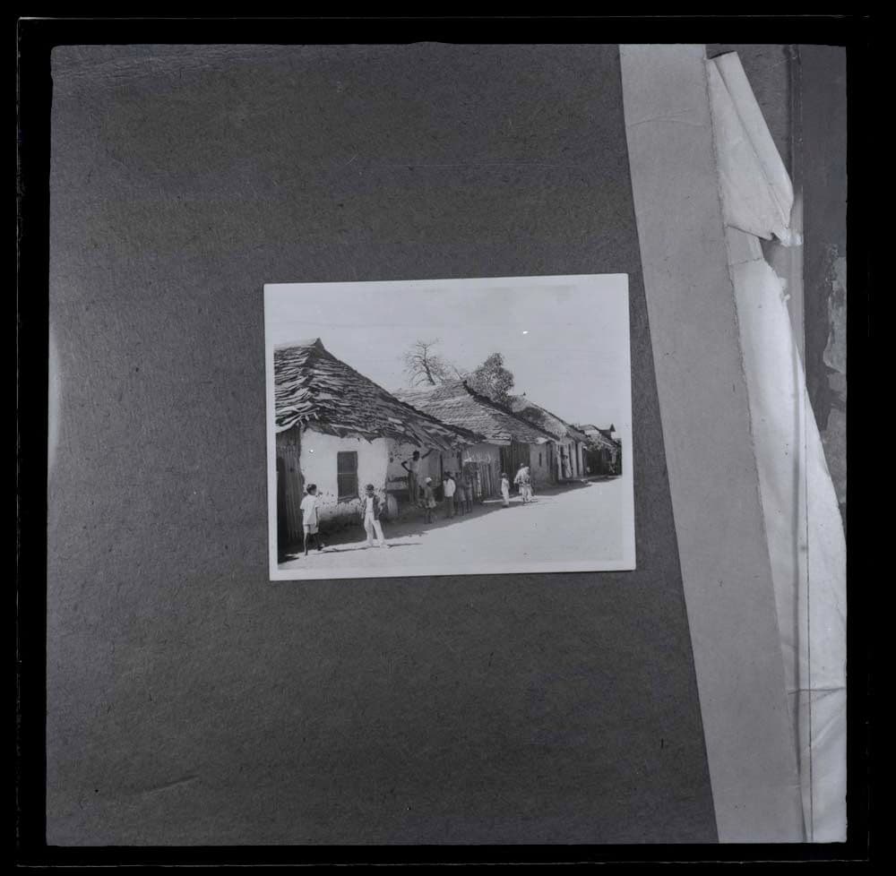 Slide taken from an unidentified publication, showing a  photograph of a typical residential settlement in Kariakoo, Tanzania in the 1950s. 