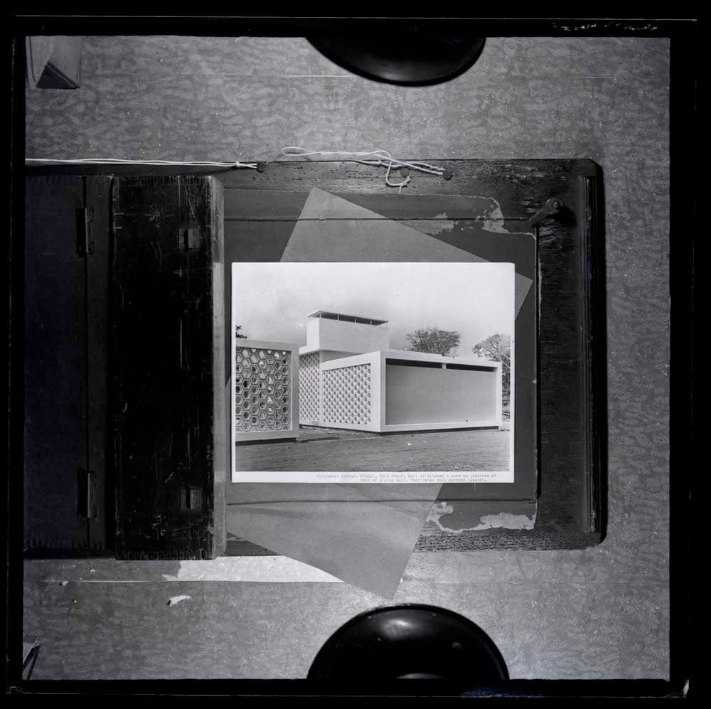 DTA Lantern Slide Library. Slide taken from an unidentified publication, showing a photograph of a part of the kitchen and service quarters at the Opoku Ware School in Kumasi, Ghana.