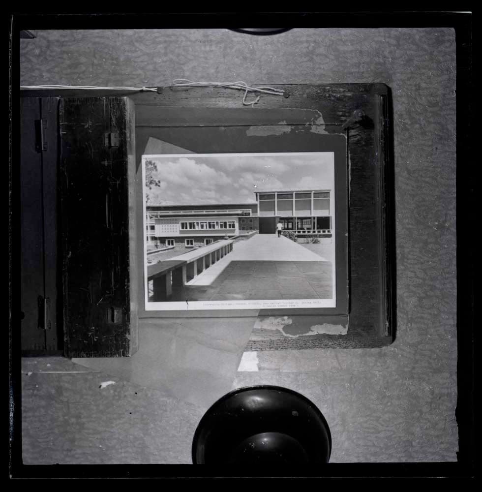DTA Lantern Slide Library. Slide taken from an unidentified publication, showing a photograph of the dining hall and senior common room of Tedder Hall, residential college 2 of the University College in Ibadan, Nigeria from the upper terrace level.