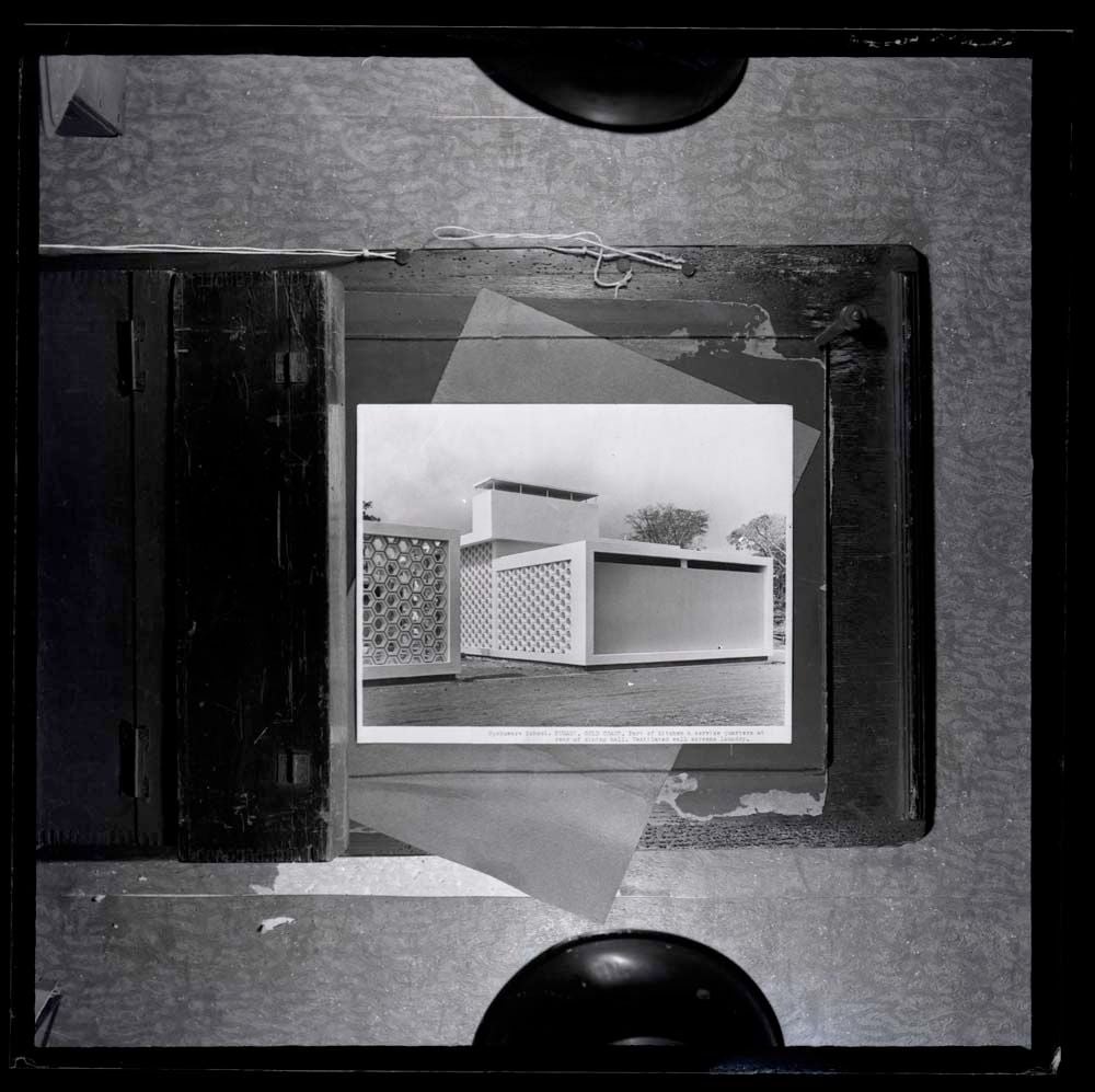 DTA Lantern Slide Library. Slide taken from an unidentified publication, showing a photograph of a part of the kitchen and service quarters at the Opoku Ware School in Kumasi, Ghana.