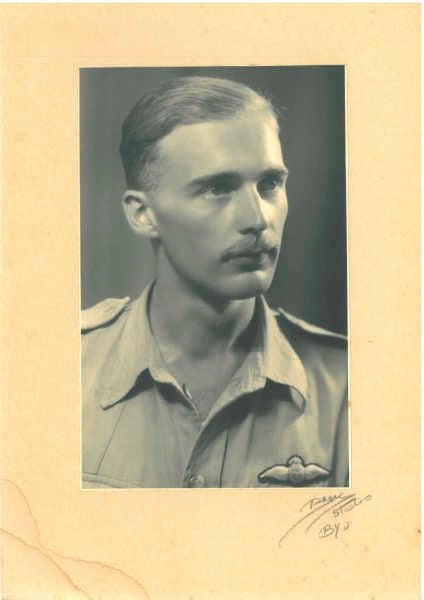 Black and white portrait of a man in a military uniform with a mustache.